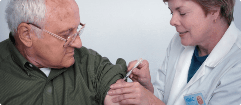 A man getting his arm examined by an eye doctor.