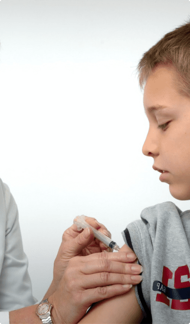 A boy is holding something in his hand.