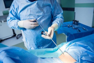 A surgeon is performing surgery on someone in the operating room.