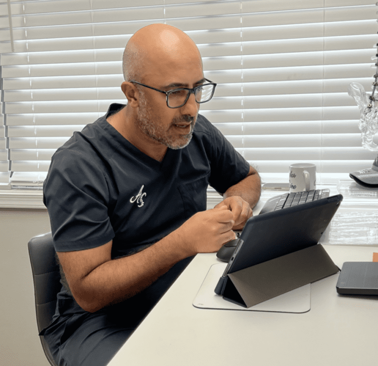 A man sitting at a table with a tablet.