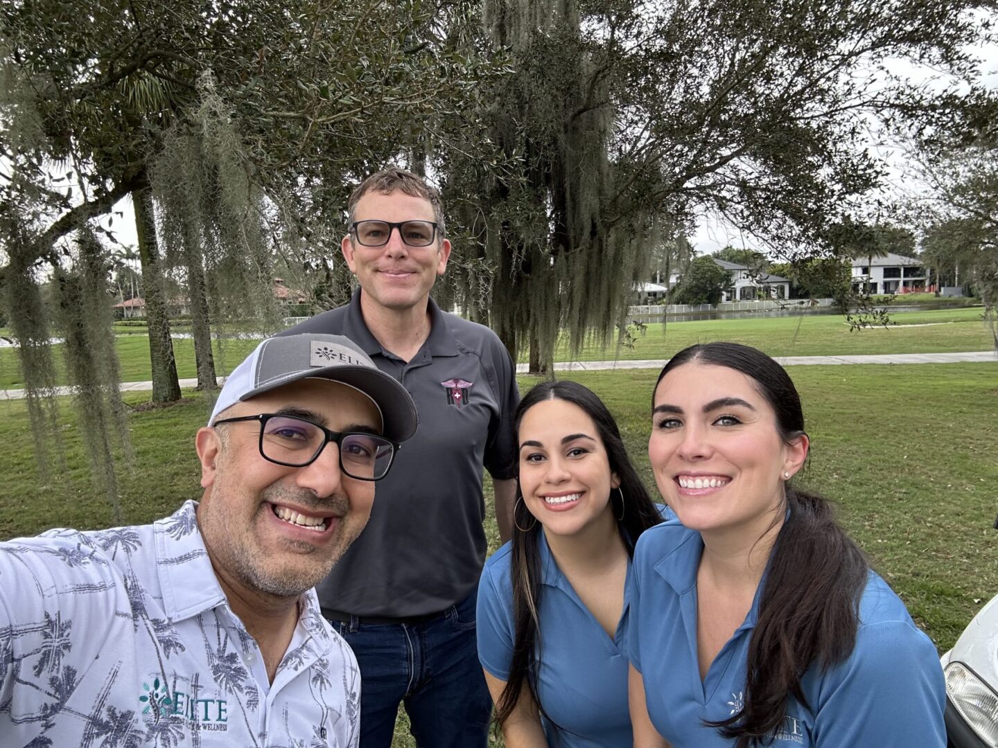 A group of people standing in the grass.